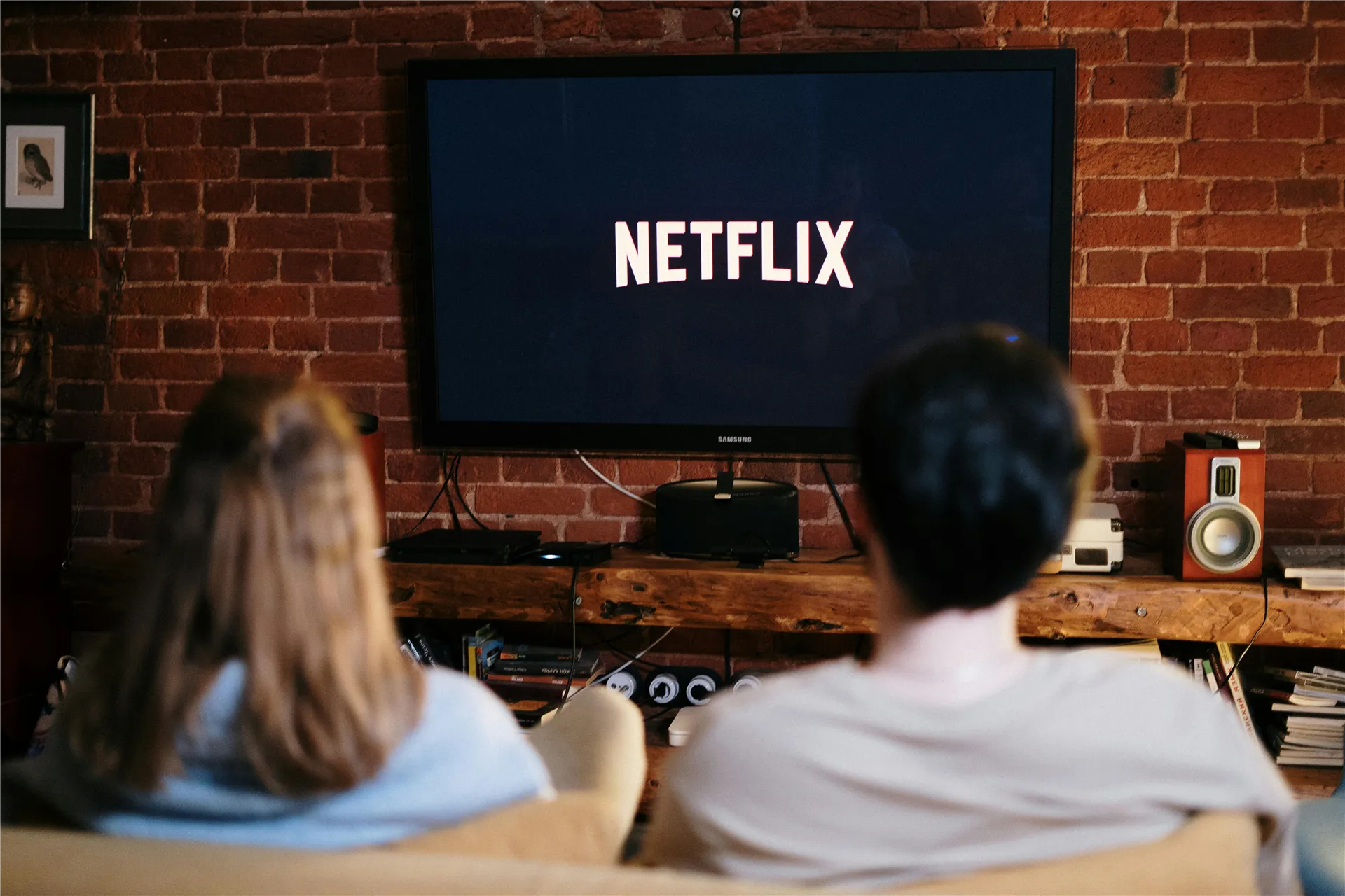 A couple relaxing and watching Netflix in a cozy living room setting.