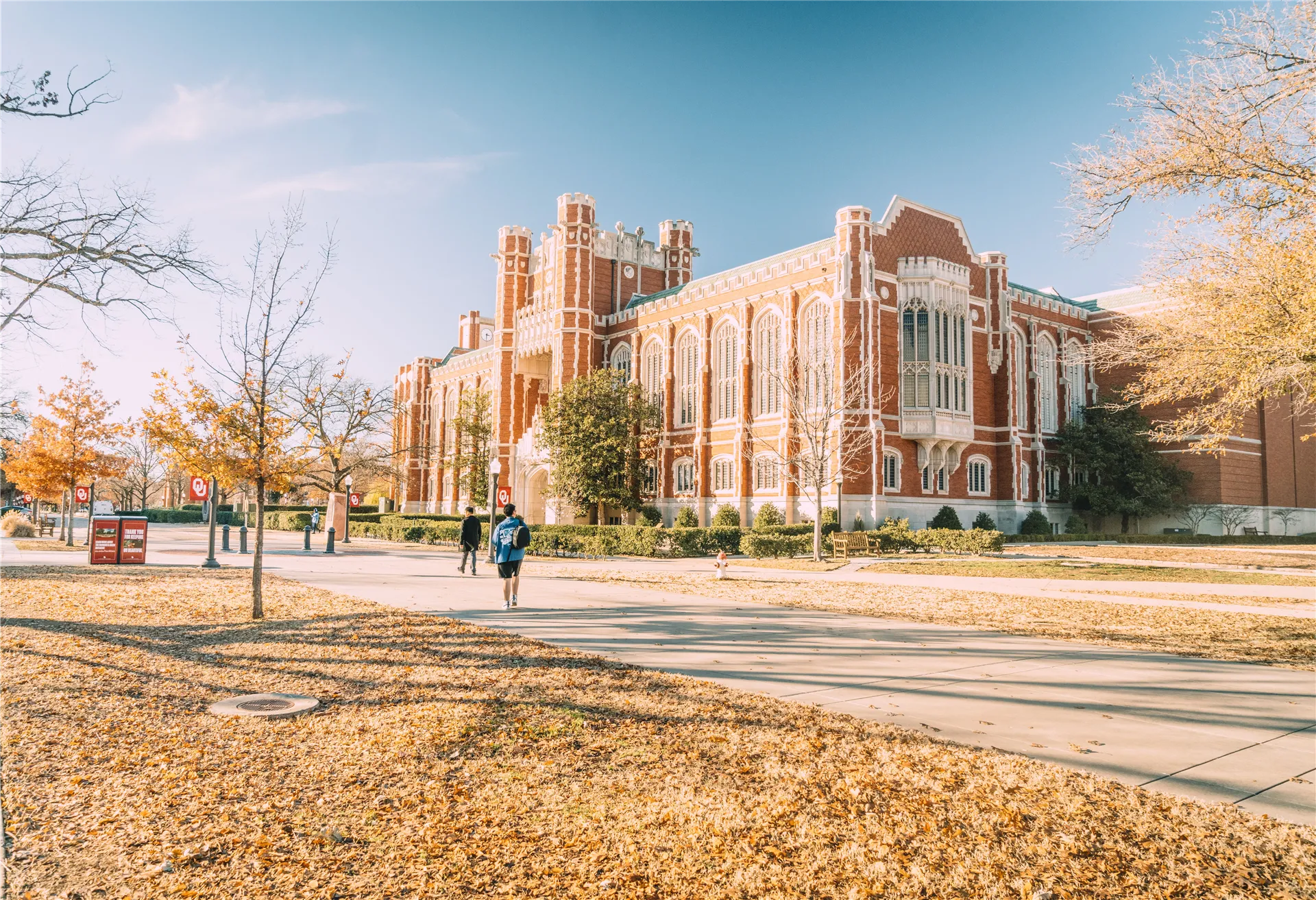 A scenic view of a historic university building surrounded by autumn foliage, reflecting academic architecture.